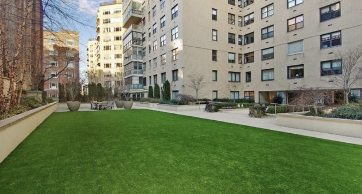 180 East End Avenue, Unit 15E Manhattan, NY 10128 - Photo 27 of 31 a view of a building with garden and bench