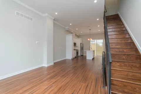 a view of a hallway with wooden floor