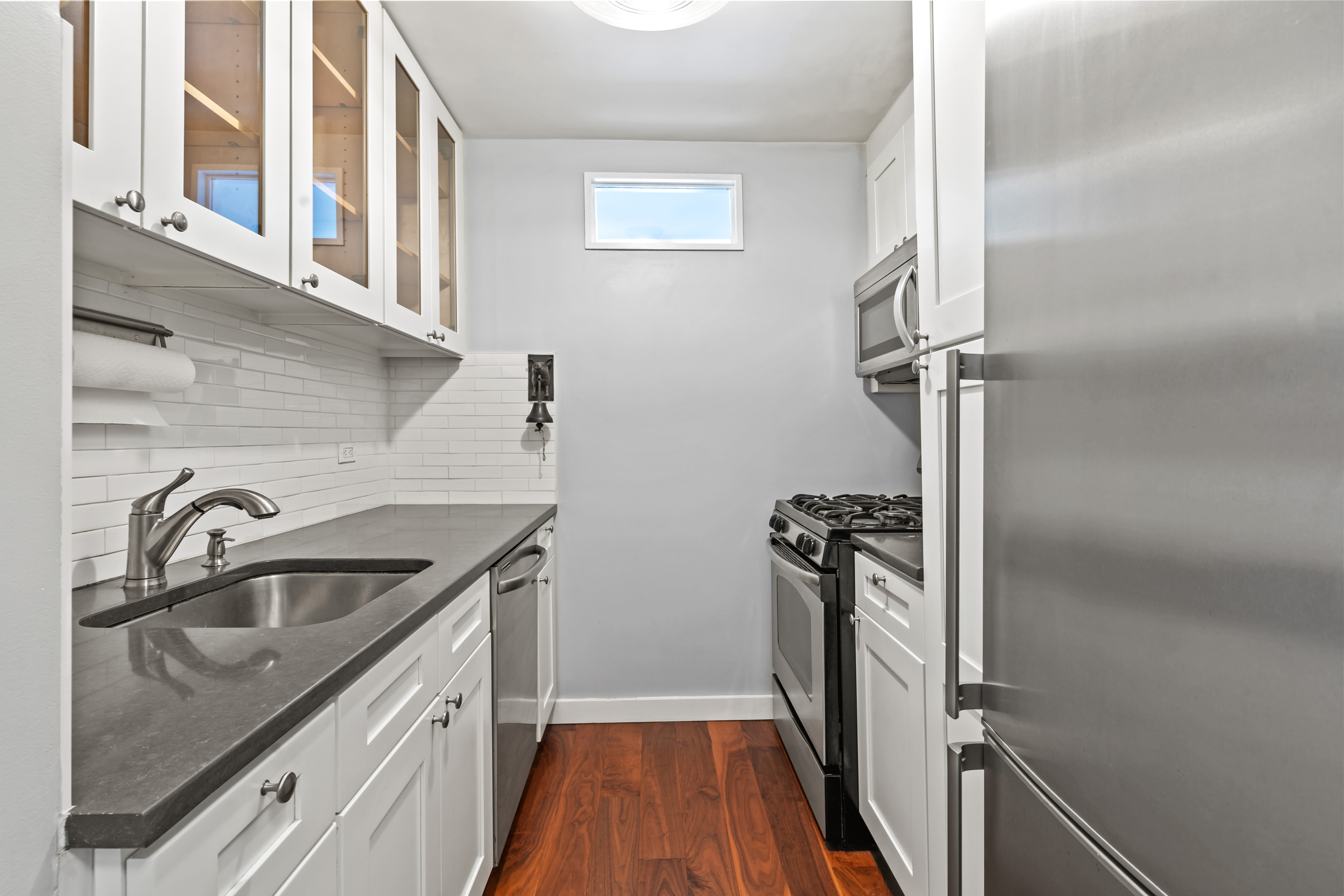 205 3rd Avenue, Unit 11T Manhattan, NY 10003 - Photo 6 of 20 a kitchen with a sink stove and refrigerator