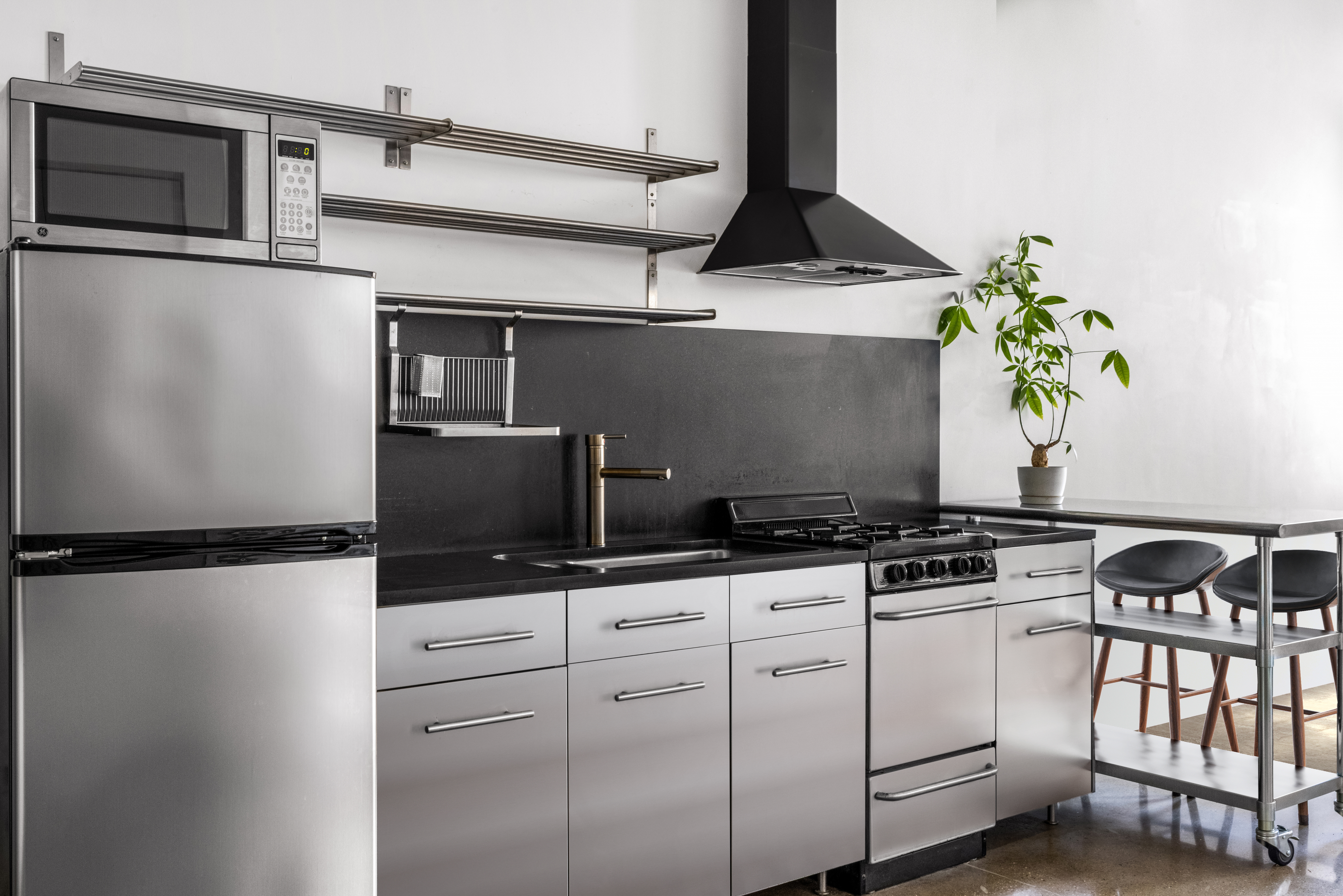315 7th Avenue, Unit 6C Manhattan, NY 10001 - Photo 5 of 10 a kitchen with stainless steel appliances a sink and a stove