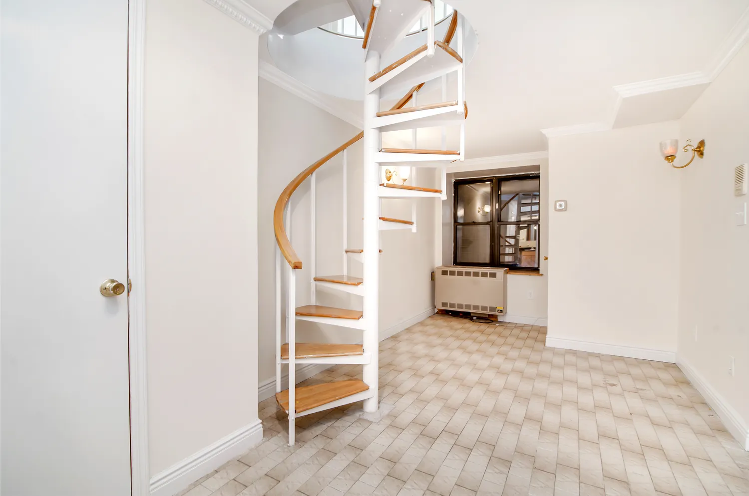 a view of a livingroom with wooden floor and stairs