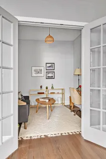 a living room with furniture and a book shelf