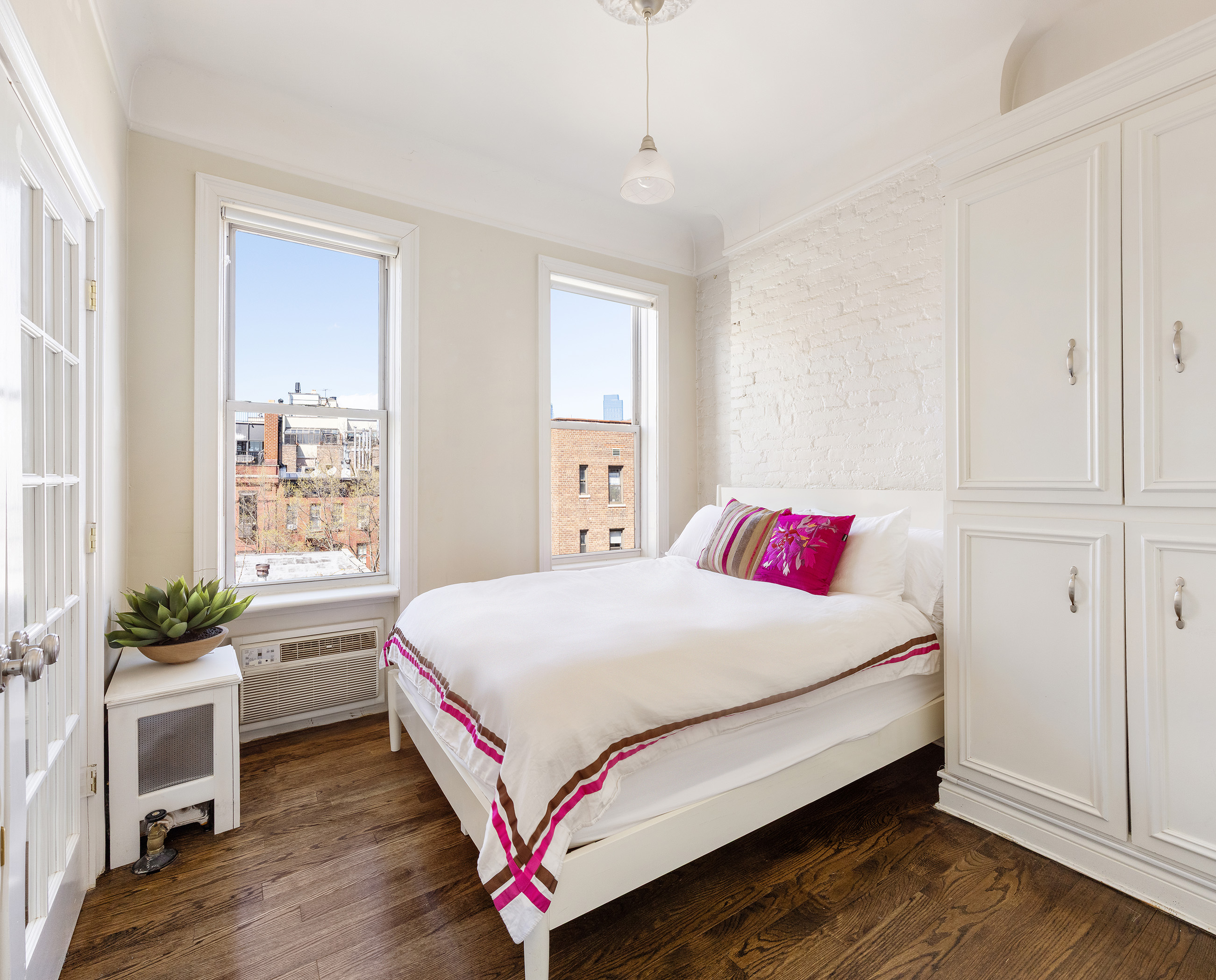 327 West 11th Street, Unit 5R Manhattan, NY 10014 - Photo 2 of 6 a bedroom with a bed and a window