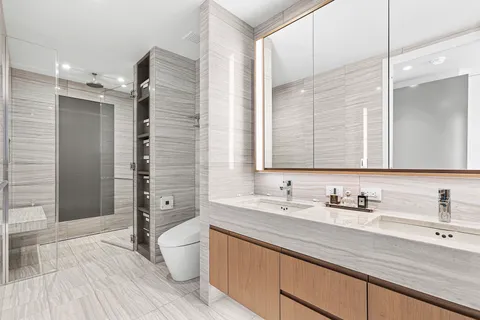 a bathroom with a sink a toilet and shower