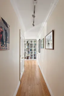 a view of a room with wooden floor and windows