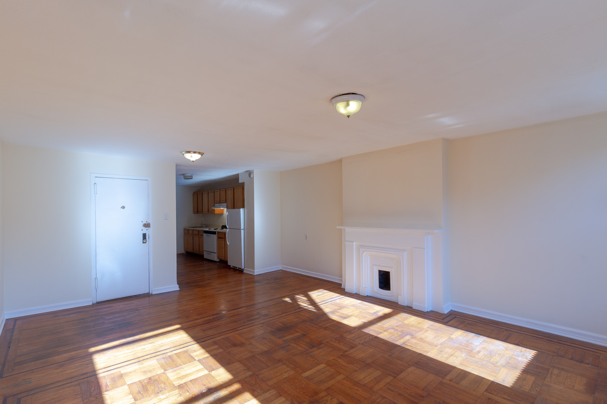 145 Atlantic Avenue, Unit 2 Brooklyn, NY 11201 - Photo 4 of 11 a view of empty room with wooden floor and fireplace