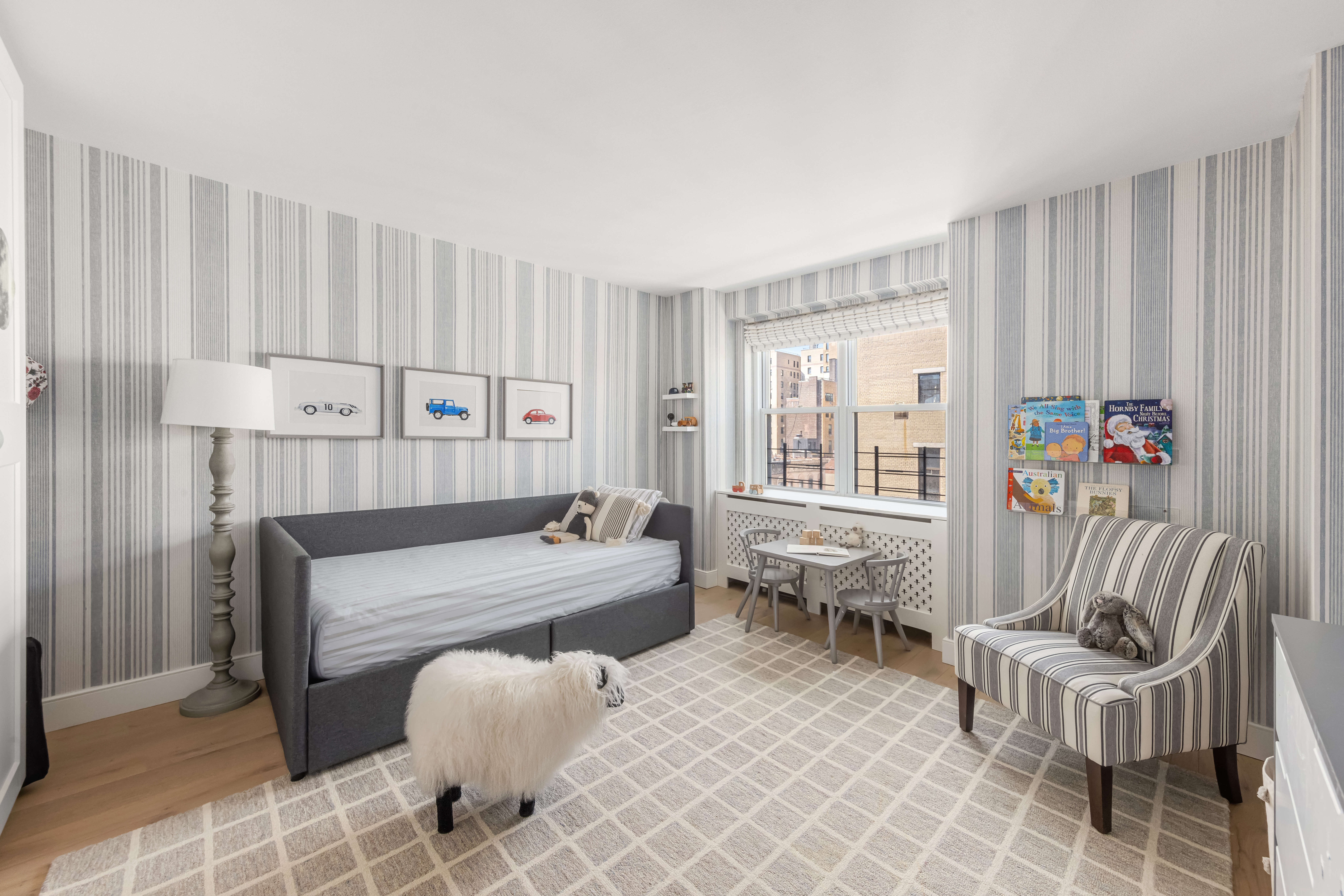 135 East 83rd Street, Unit 8/9C Manhattan, NY 10028 - Photo 8 of 15 a bedroom with furniture and a large window