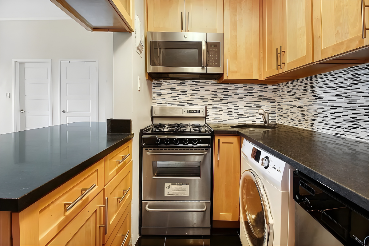 219 West 14th Street, Unit 4F Manhattan, NY 10011 - Photo 3 of 7 a kitchen with a stove and a microwave