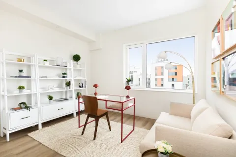 a living room with furniture cabinets and window