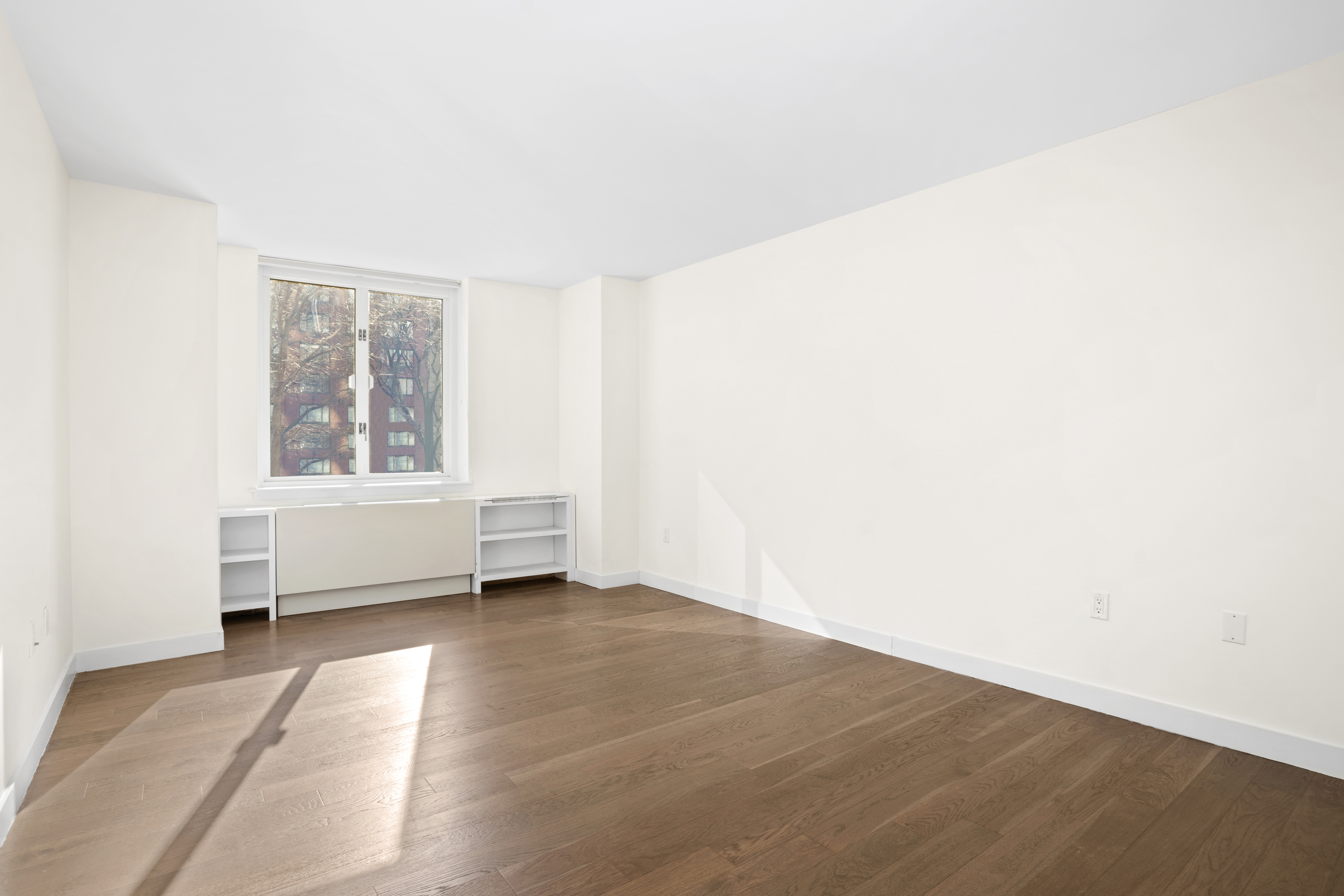225 Rector Place, Unit 2D Manhattan, NY 10280 - Photo 6 of 17 a view of an empty room with a window