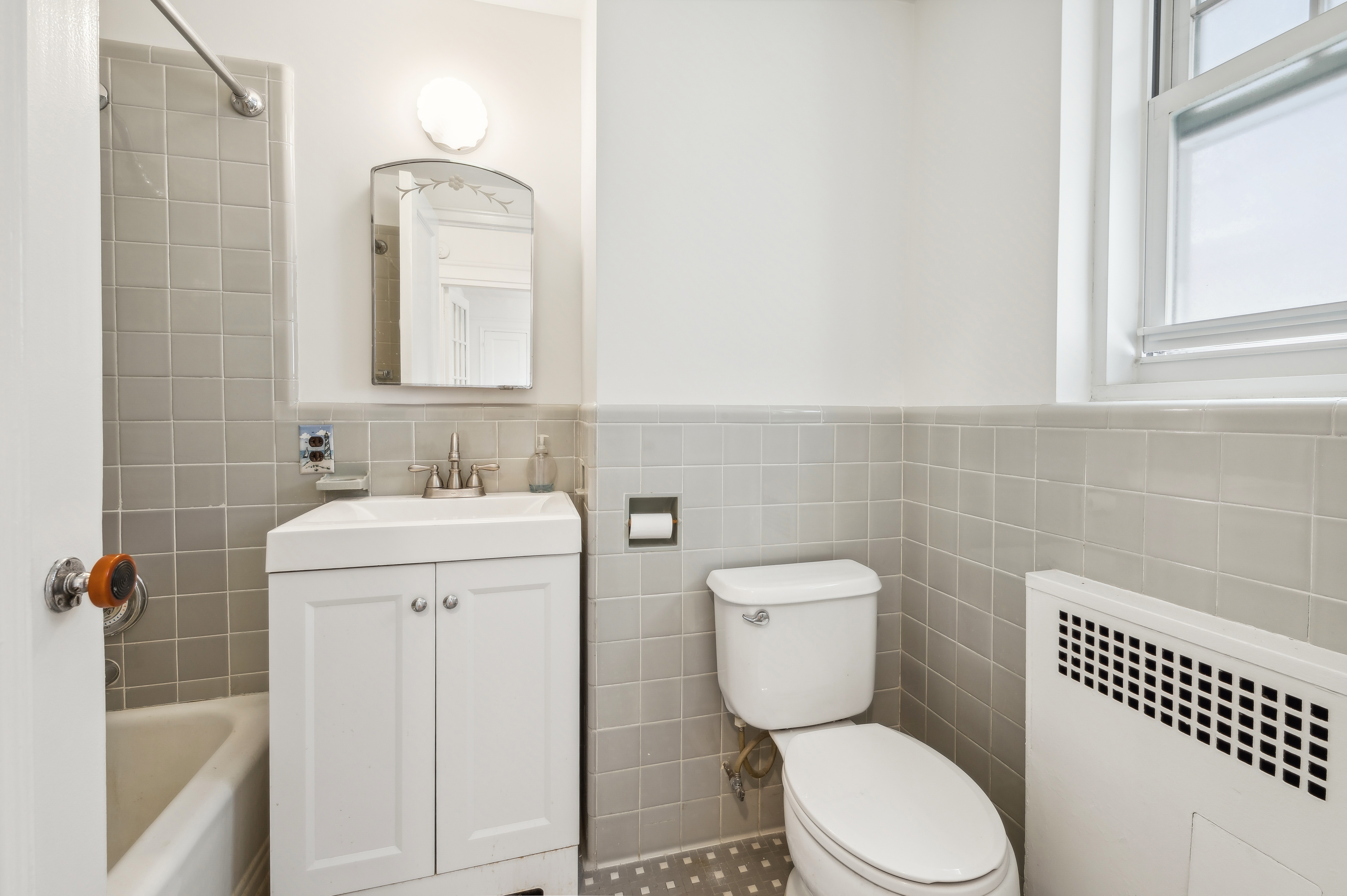 180 Cabrini Boulevard, Unit 98 Manhattan, NY 10033 - Photo 6 of 7 a bathroom with a toilet sink and mirror