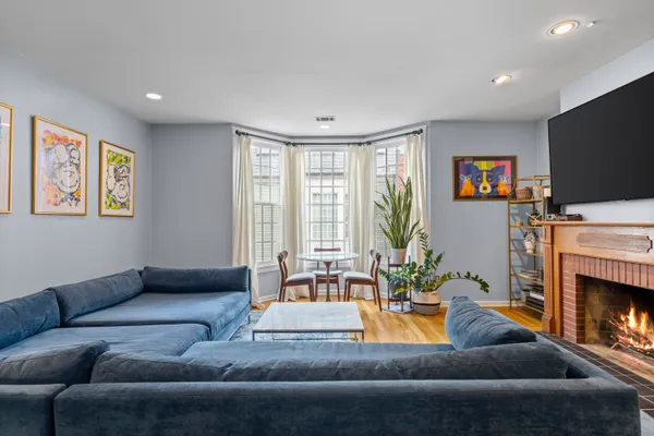 a living room with furniture fireplace and flat screen tv