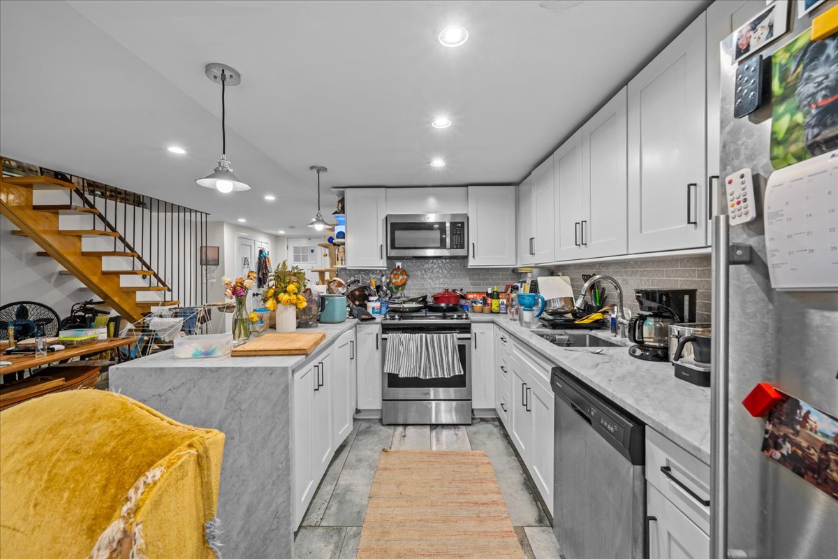 1509 Dean Street, Unit MULTI Brooklyn, NY 11213 - Photo 3 of 12 a kitchen with stainless steel appliances granite countertop a sink and cabinets