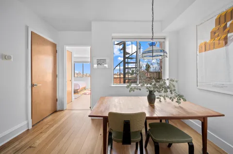 a view of a dining room with furniture wooden floor and chandelier