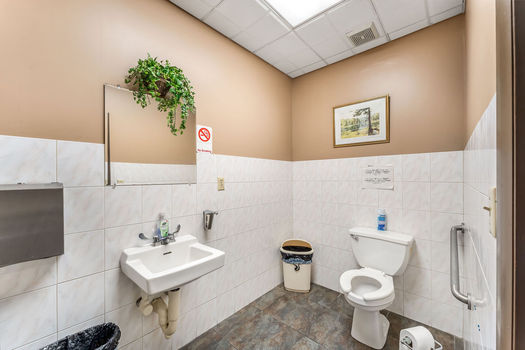 869 Bergen Avenue, Unit COMMERCIAL Jersey City, NJ 07306 - Photo 10 of 26 a bathroom with a sink mirror vanity and toilet
