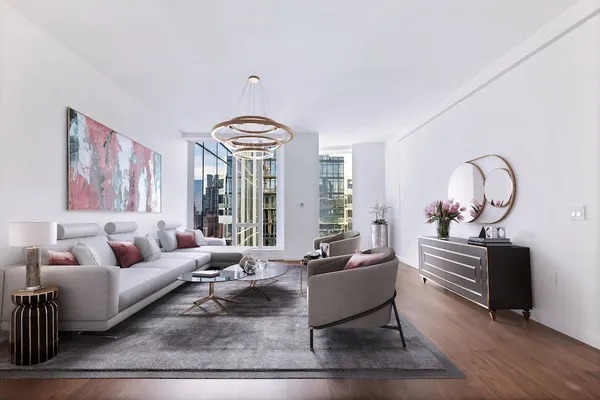 a living room with furniture chandelier and a table