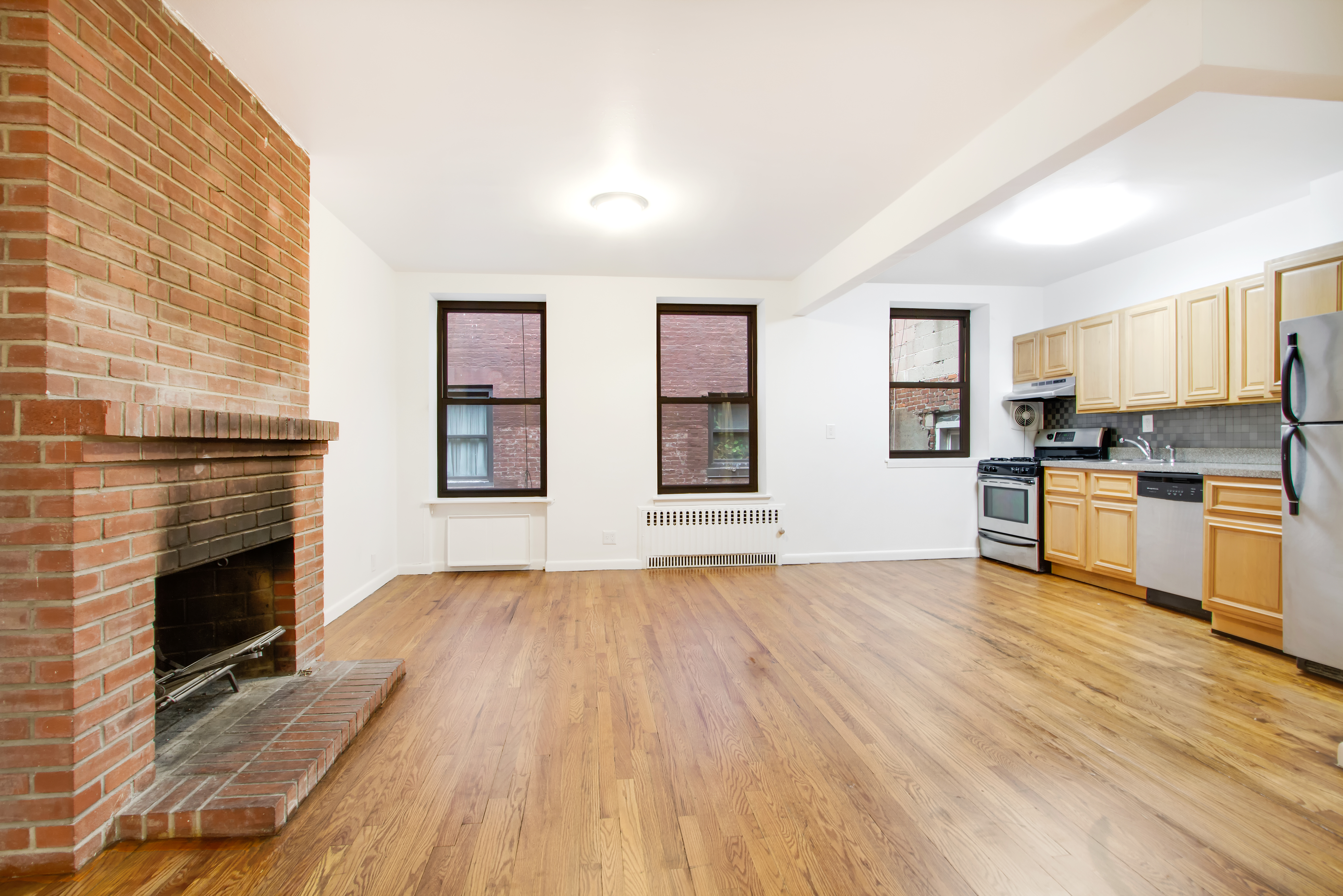 248 3rd Avenue, Unit 3 Manhattan, NY 10010 - Photo 2 of 5 a view of kitchen with granite countertop stove top oven and cabinets