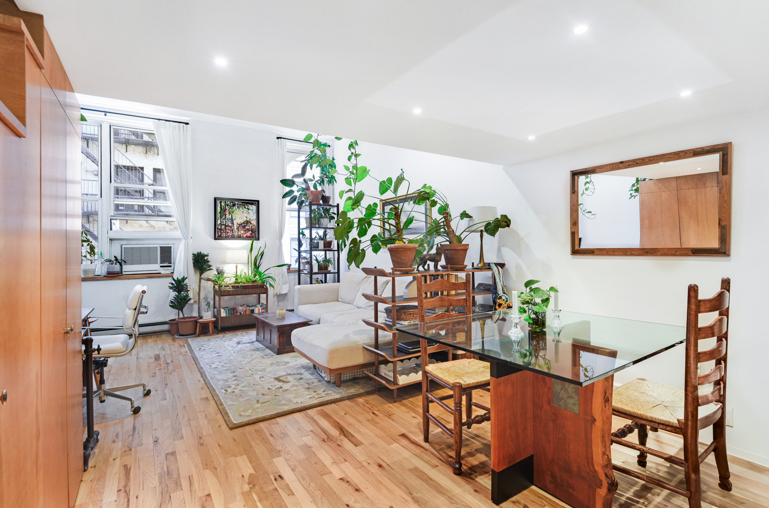 23 Waverly Place, Unit 5U Manhattan, NY 10003 - Photo 7 of 13 a living room with furniture and a wooden floor
