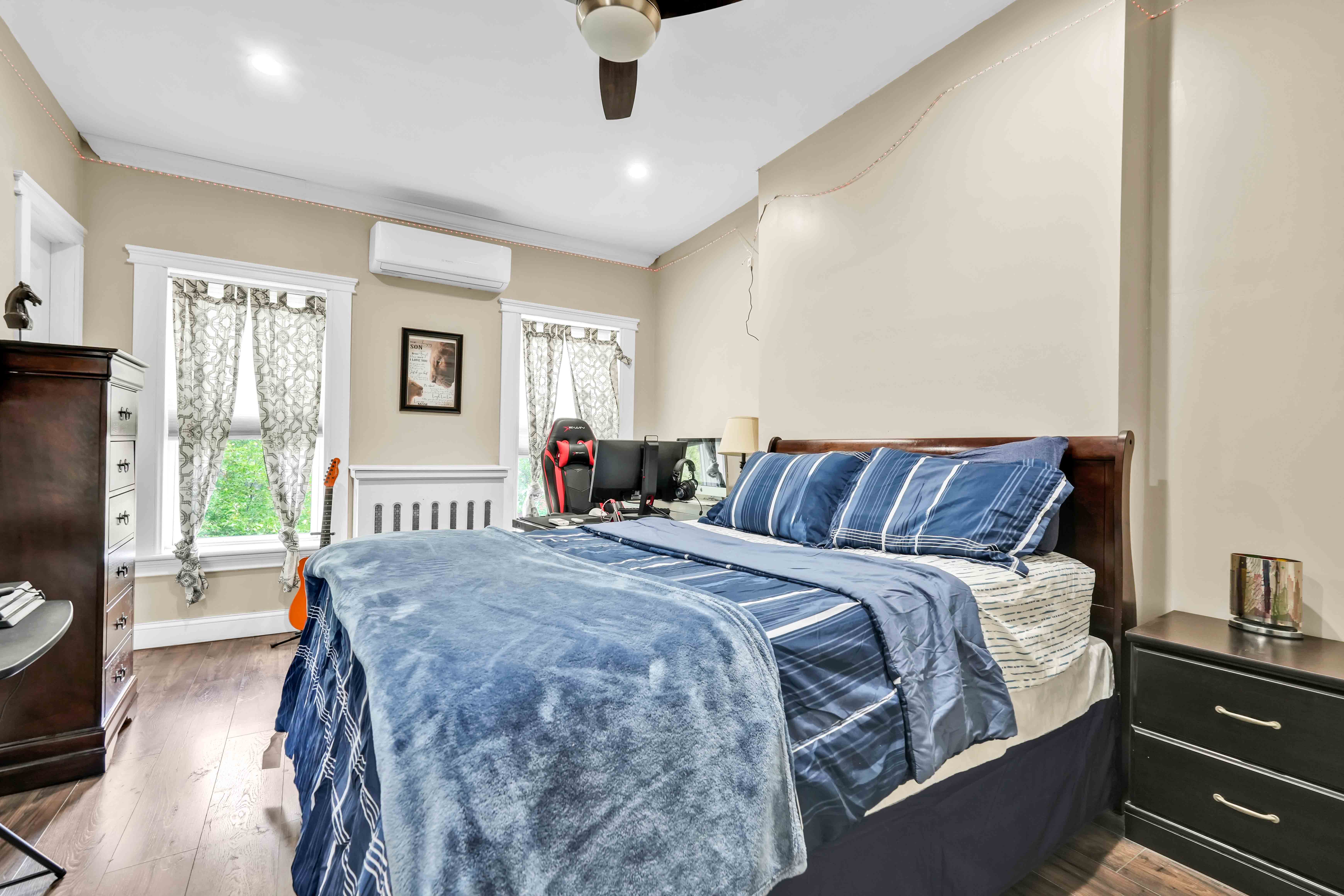 519 Monroe Street Brooklyn, NY 11221 - Photo 24 of 55 a bed sitting in a bedroom next to a window with a flat screen tv