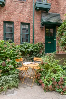 a front view of a house with outdoor seating and plants