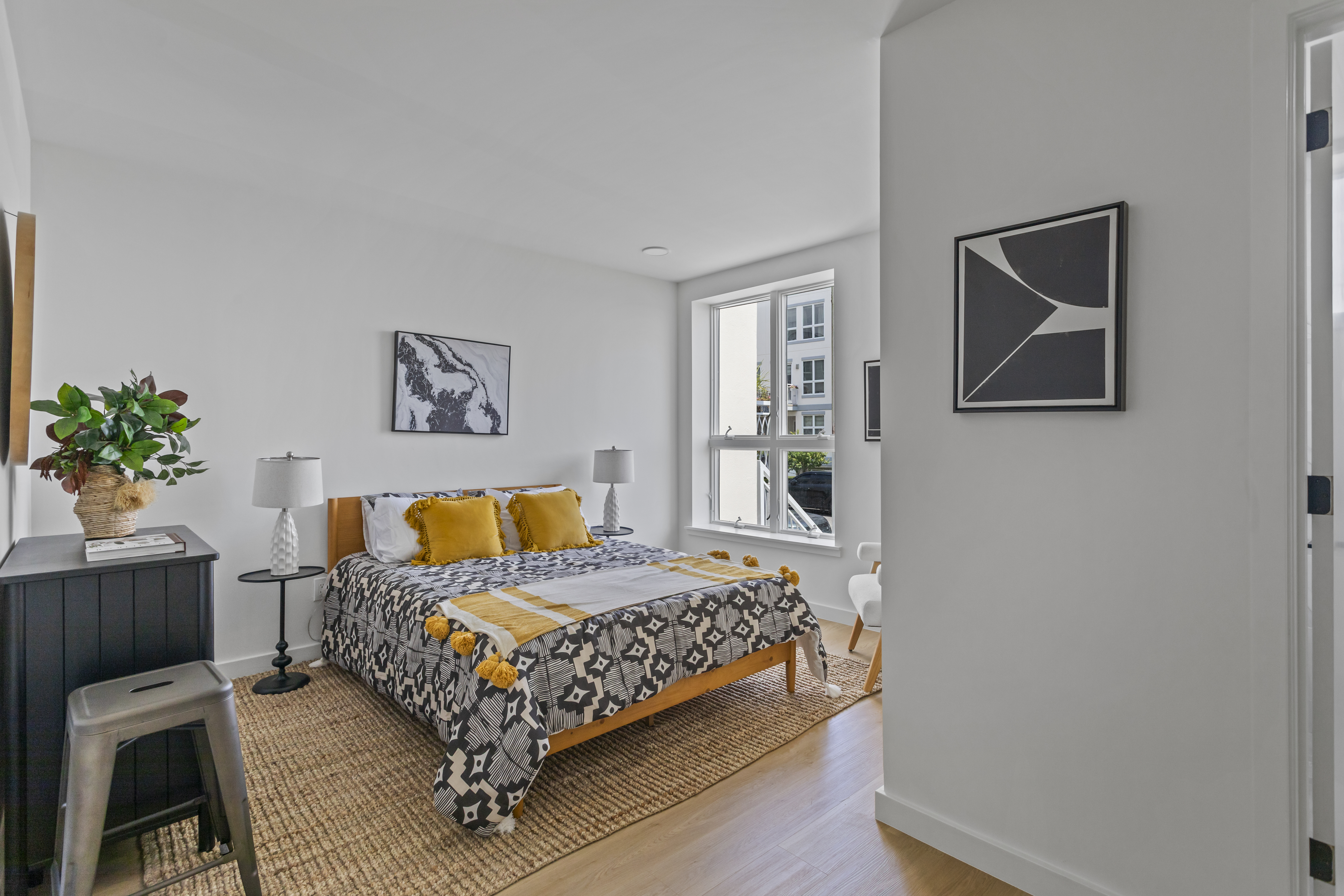 3112 Emmons Avenue, Unit 3124A2 Brooklyn, NY 11235 - Photo 5 of 17 a bedroom with a bed painting on wall and a potted plant