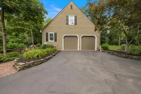 a view of a house with a yard and garage