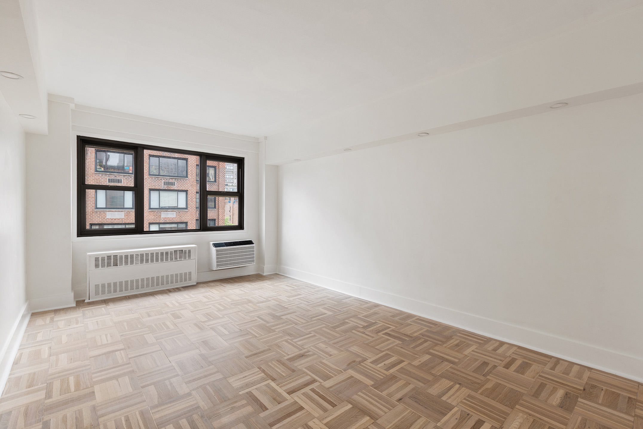 335 East 51st Street, Unit 9D Manhattan, NY 10022 - Photo 8 of 14 a view of an empty room with a window