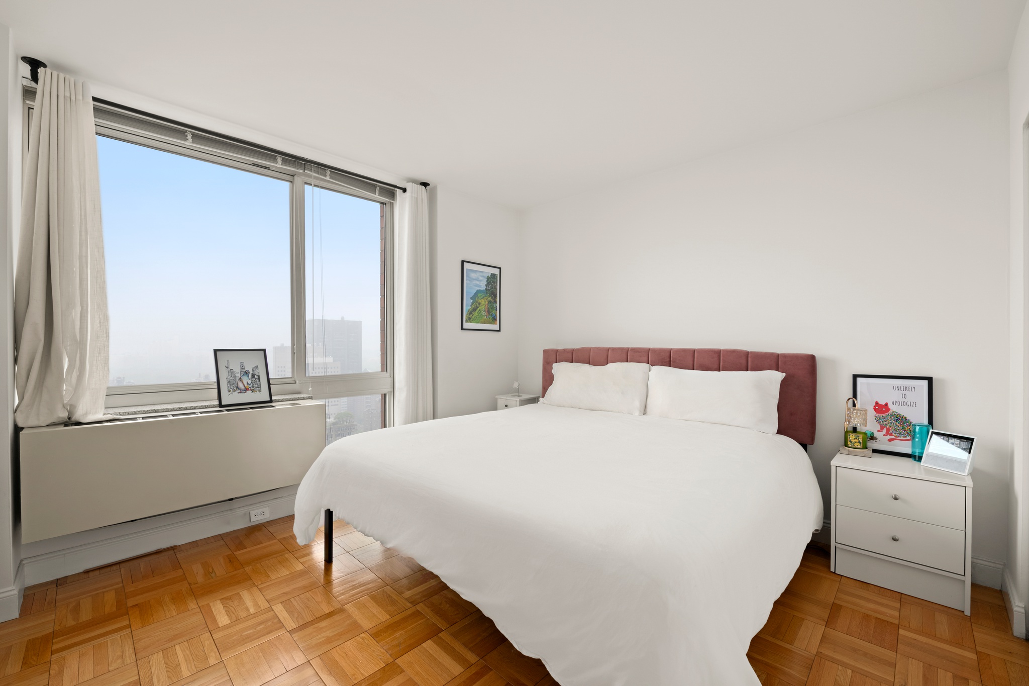 215-217 East 96th Street, Unit 40E Manhattan, NY 10128 - Photo 4 of 7 a bedroom with a bed and a large window