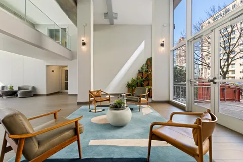 a view of a patio with table and chairs and potted plants