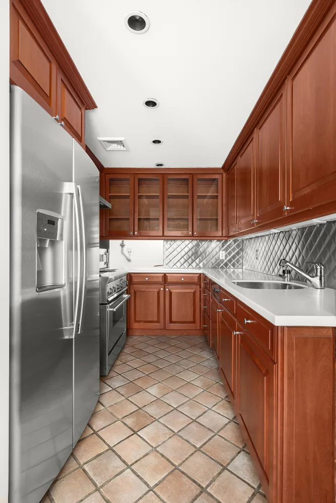 a kitchen with stainless steel appliances granite countertop a sink stove and refrigerator