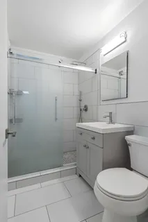 a bathroom with a toilet sink and shower