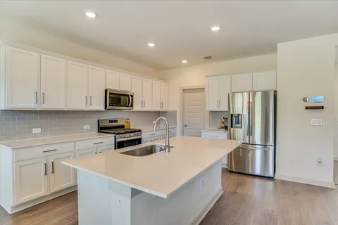 a kitchen with a refrigerator stove and microwave
