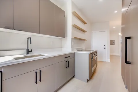 a kitchen with a sink stove and refrigerator