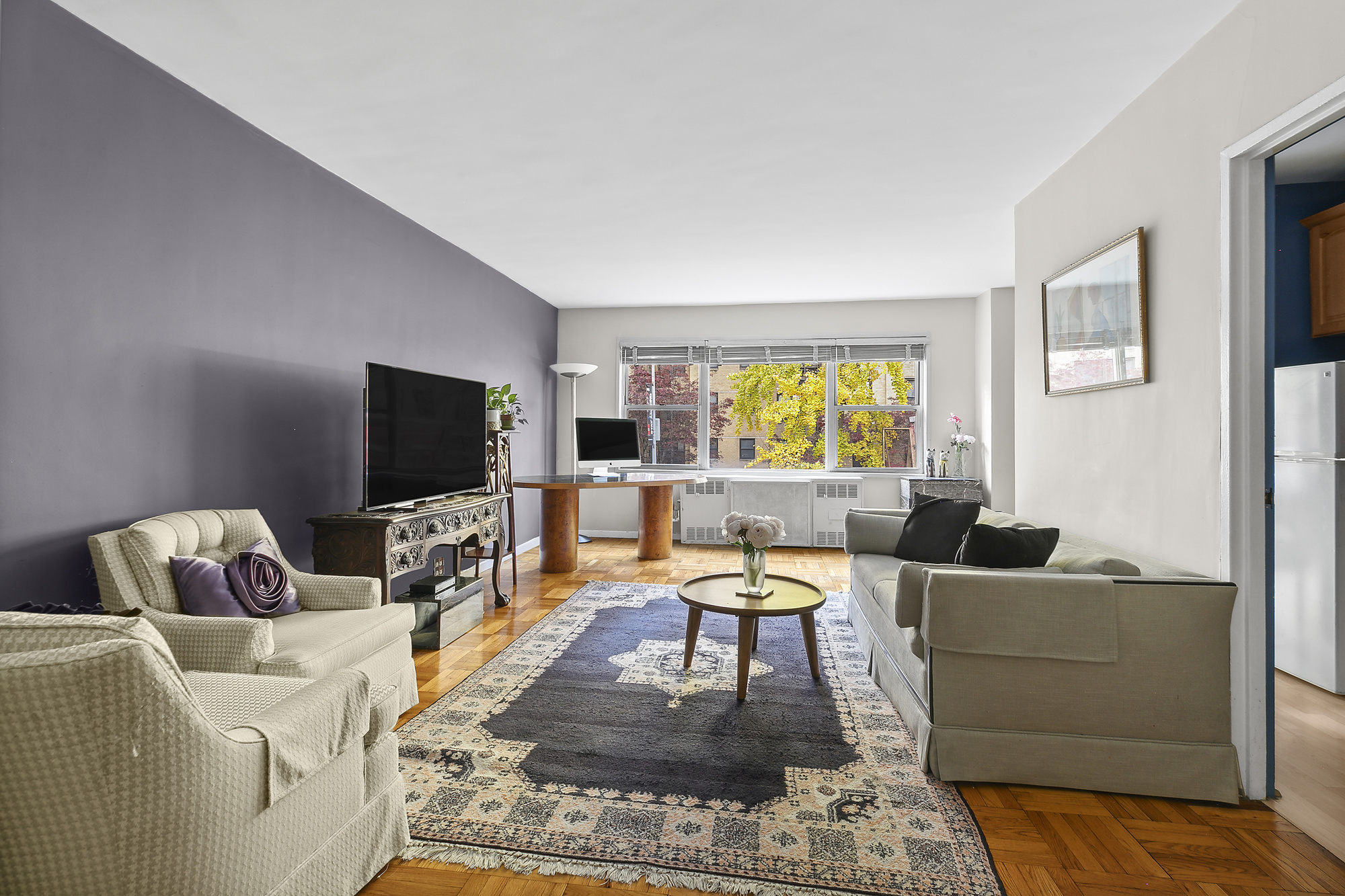 a living room with furniture and a flat screen tv