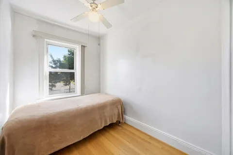 a bed sitting in a bedroom next to a window