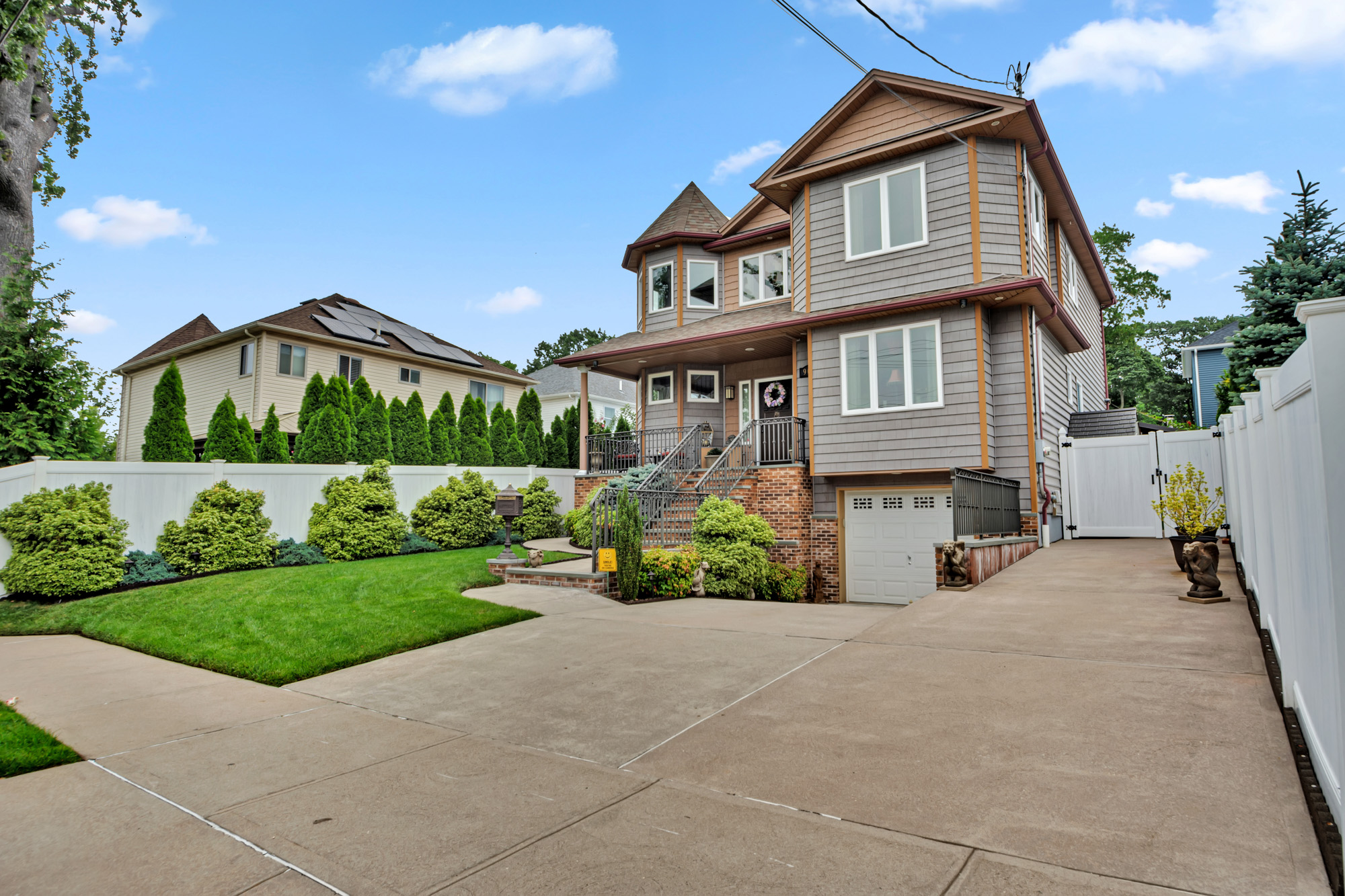 909 Jewett Avenue Staten Island, NY 10314 - Photo 65 of 65 a front view of a house with a yard and potted plants