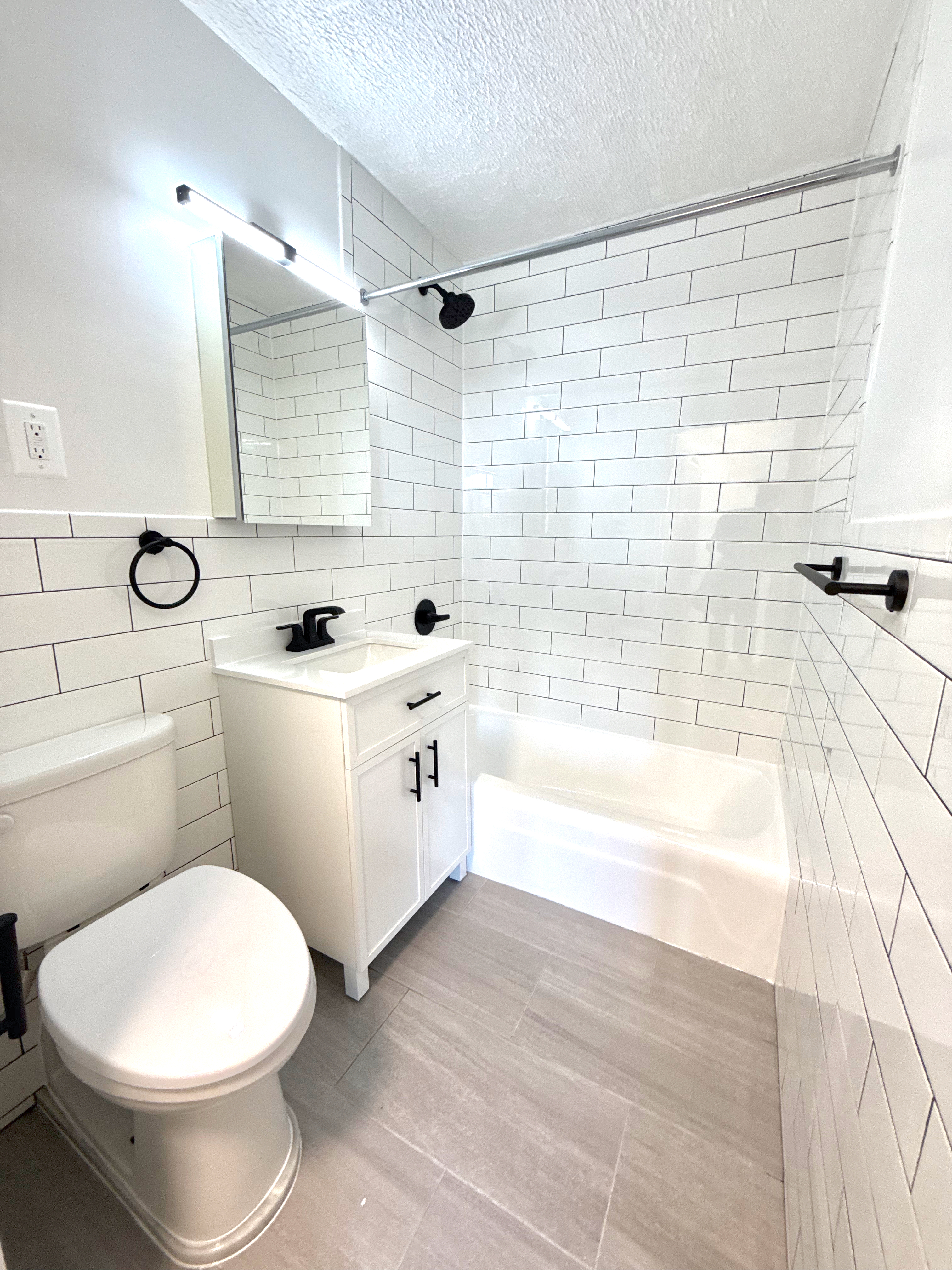 3333 Broadway, Unit D8J Manhattan, NY 10031 - Photo 8 of 22 a bathroom with a sink a toilet and bathtub