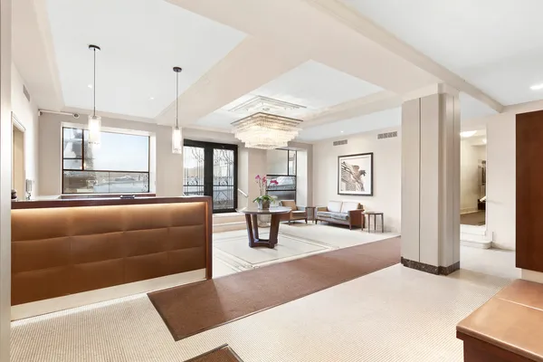 a living room with furniture and large windows