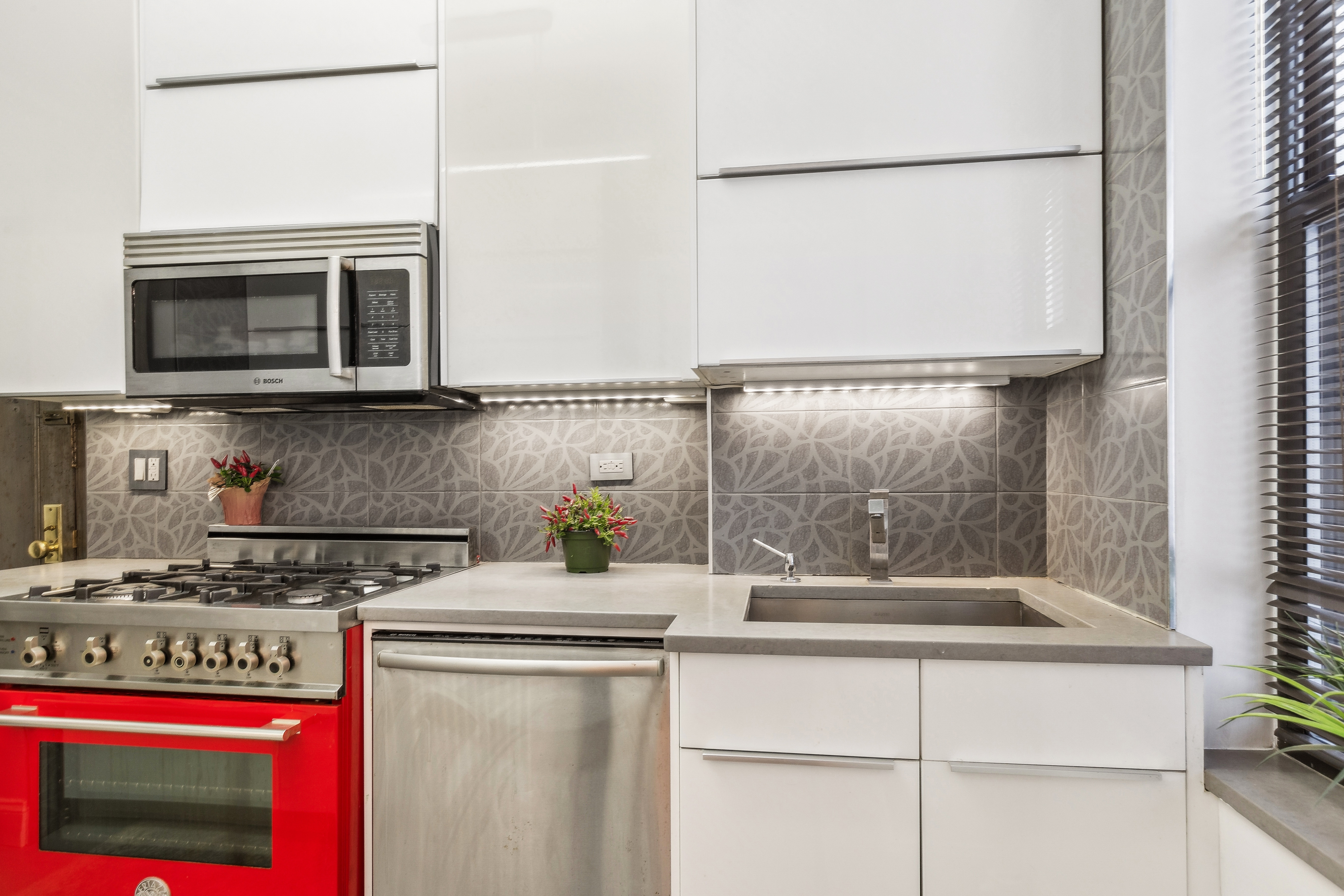 300 Riverside Drive, Unit 5E Manhattan, NY 10025 - Photo 6 of 11 a kitchen with stainless steel appliances granite countertop a stove a microwave and a refrigerator