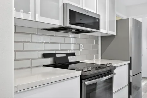 a kitchen with a stove and a refrigerator