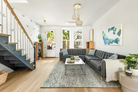 a living room with furniture and painting on the wall