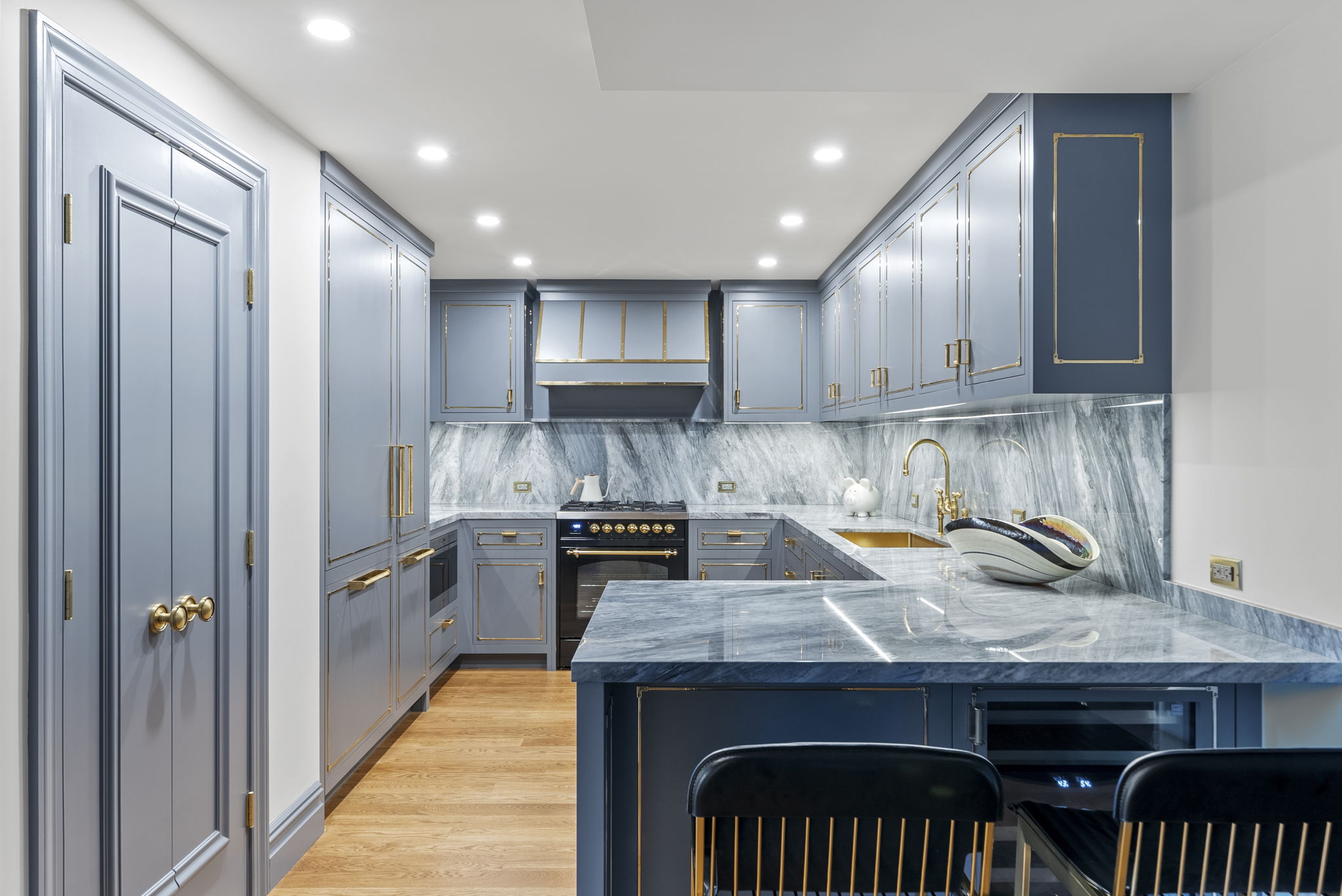 230 Central Park South, Unit 6DE Manhattan, NY 10019 - Photo 7 of 23 a kitchen with granite countertop kitchen island stainless steel appliances a refrigerator sink stove microwave and cabinets
