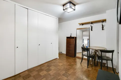 a view of a room with furniture and wooden floor