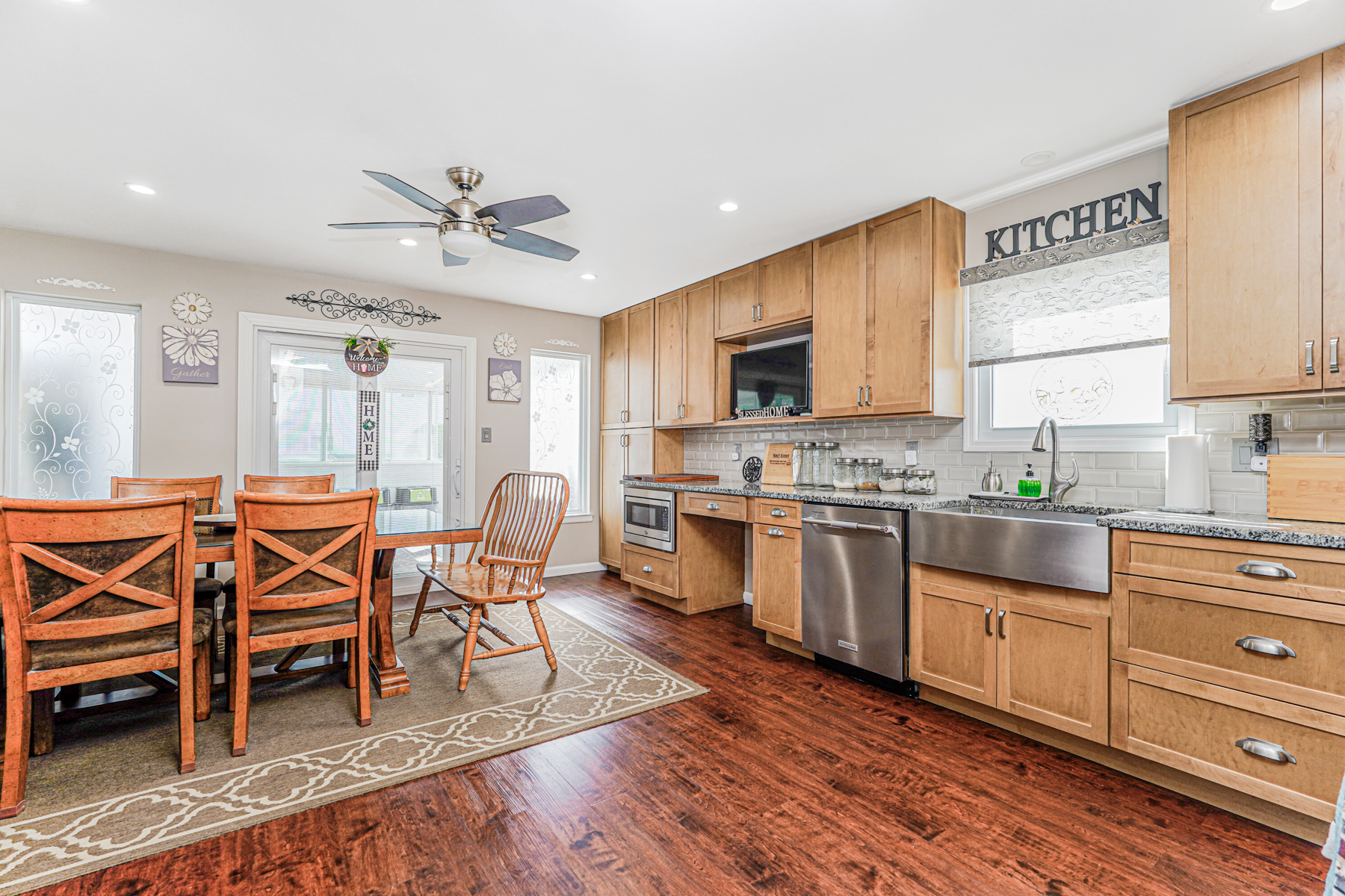 287 Greaves Avenue Staten Island, NY 10308 - Photo 11 of 35 a kitchen with stainless steel appliances a stove a sink dishwasher a microwave oven with cabinets and wooden floor