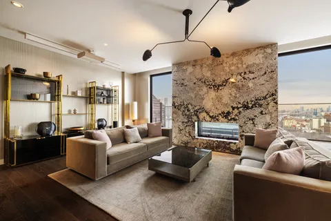 a living room with patio couch and a fireplace