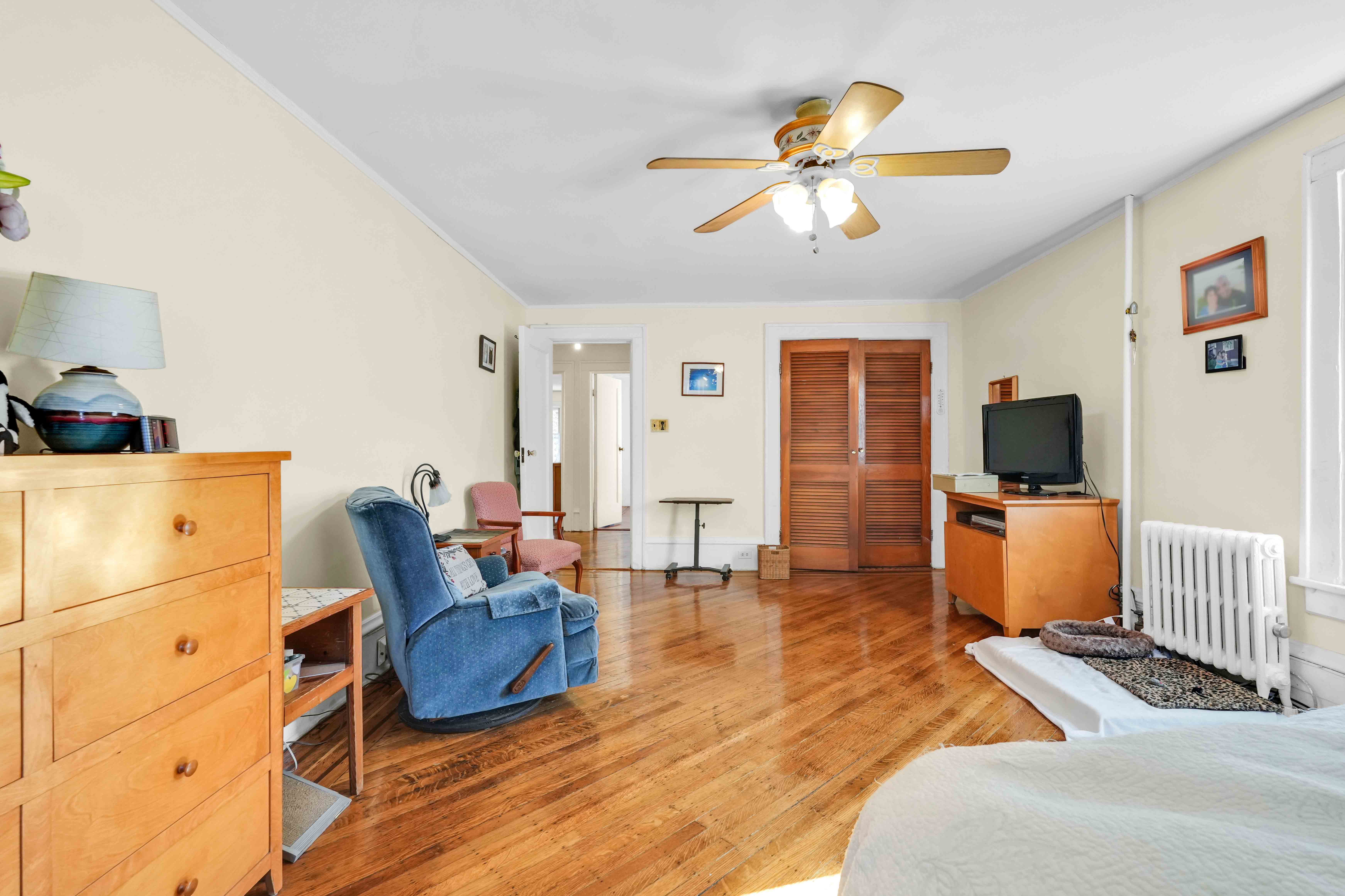 642 East 26th Street Brooklyn, NY 11210 - Photo 13 of 32 a living room with furniture and a flat screen tv