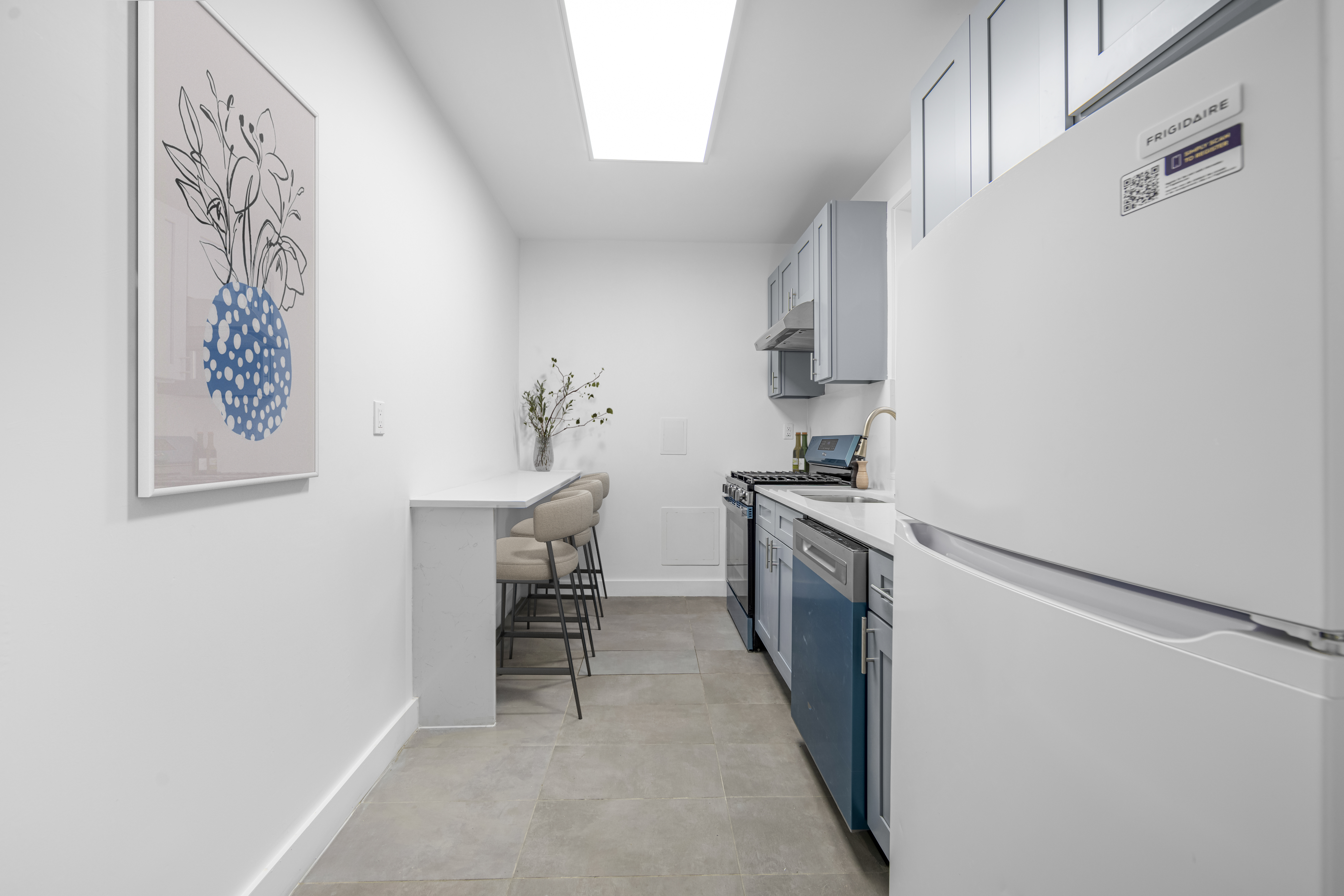 210 Grand Street, Unit 3F Manhattan, NY 10013 - Photo 7 of 11 a kitchen with a refrigerator and a stove top oven
