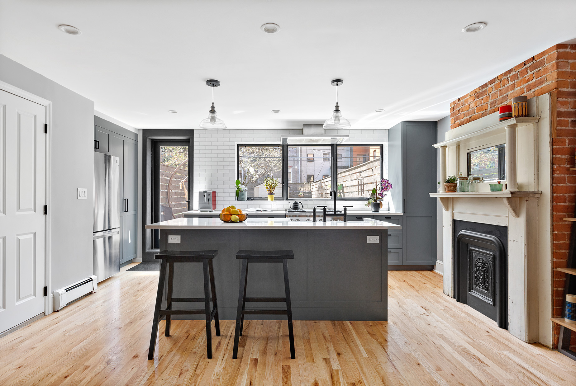 232 Monroe Street Brooklyn, NY 11216 - Photo 4 of 21 a kitchen with stainless steel appliances granite countertop a kitchen island hardwood floor sink stove dining table and chairs
