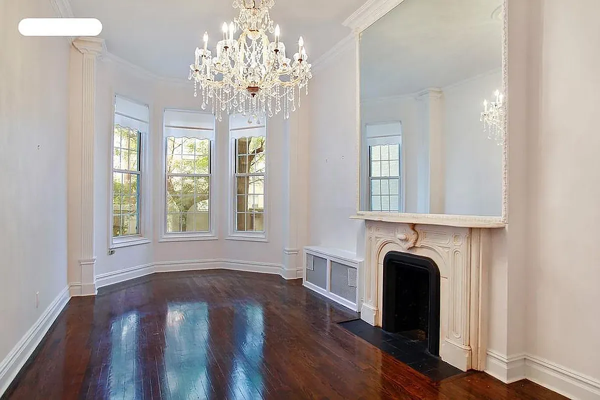 177 East 70th Street Manhattan, NY 10021 - Photo 3 of 14 a view of livingroom with chandelier and wooden floor