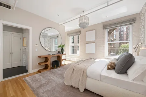 a bedroom with bed and a window